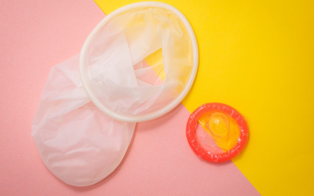 Condoms over a pink and yellow background